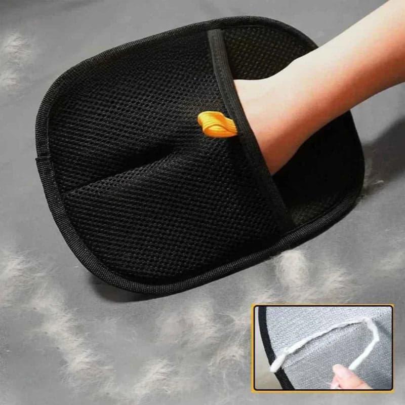 Black mesh foot scrubber with a person using it on a gray surface.